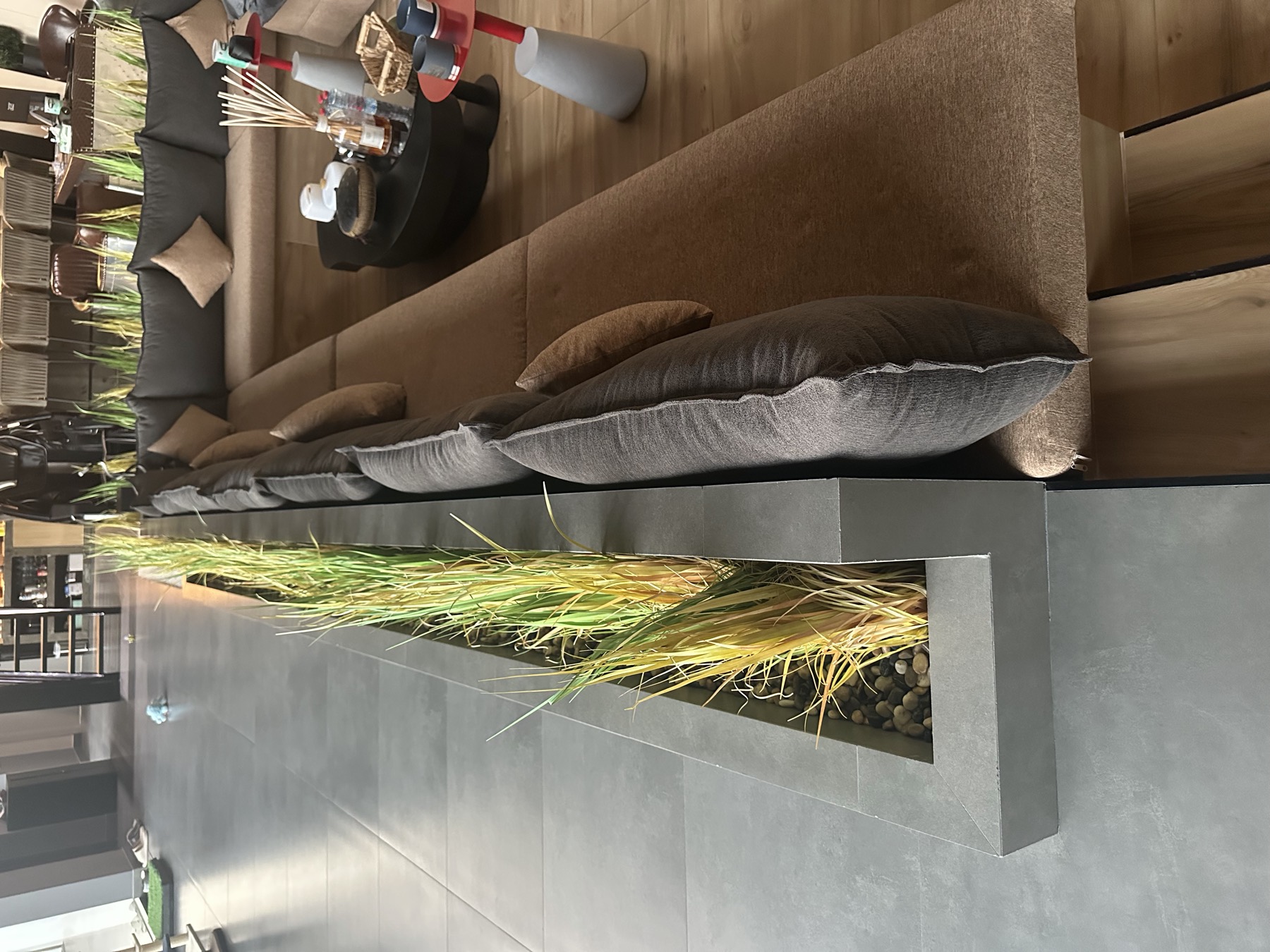 Built-in banquette seating alongside a planted stone trough with pebbles