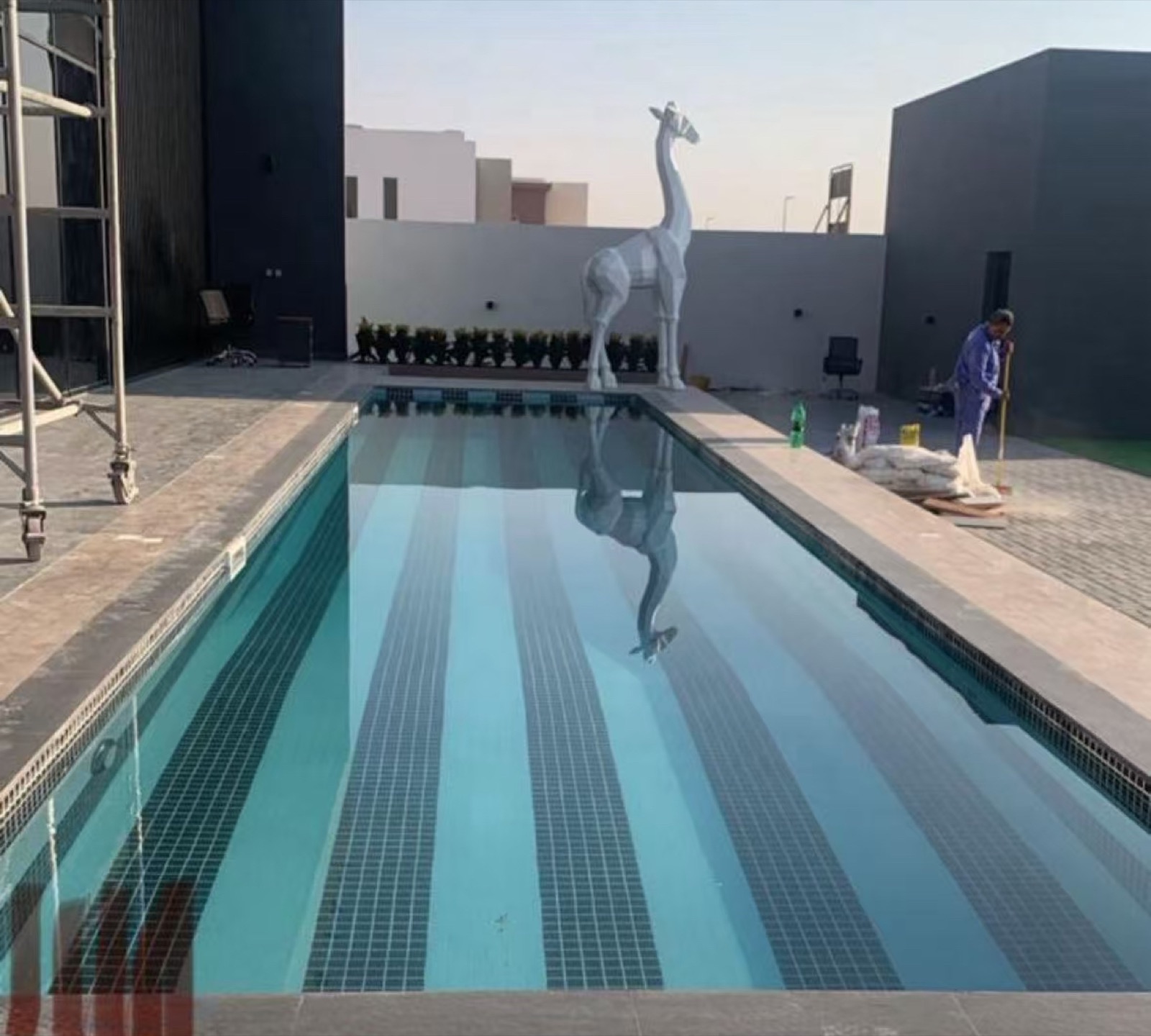The same swimming pool during construction, tiling complete at first fill