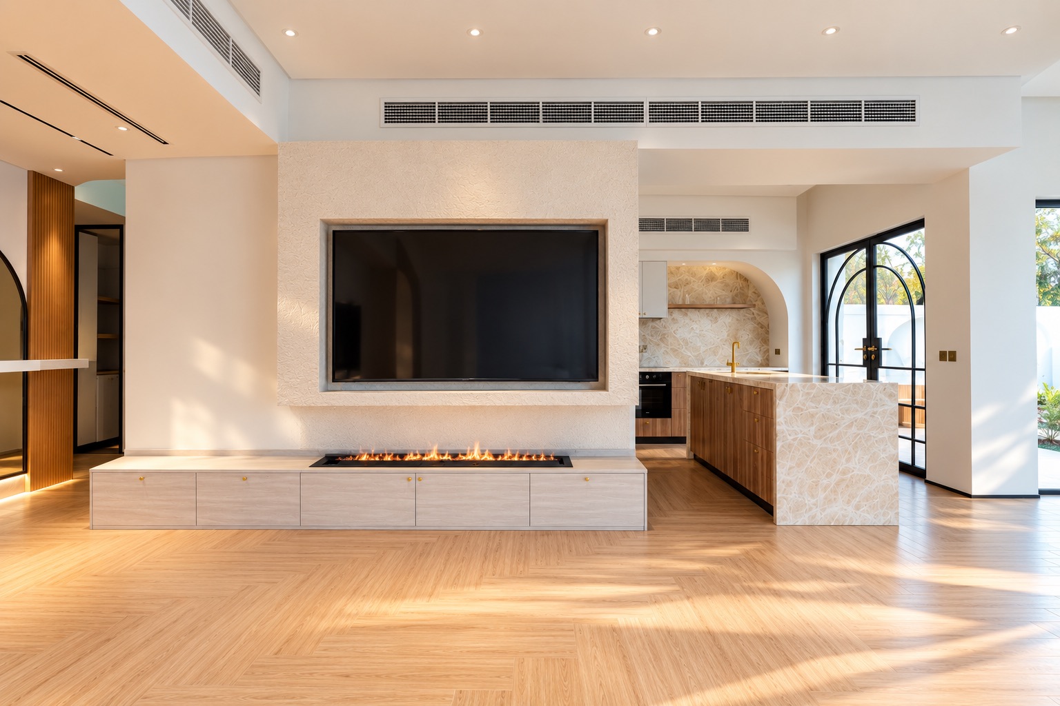 Living room with linear fireplace in a textured plaster media wall and an onyx kitchen island beyond